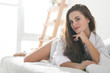 © LIGHTFIELD STUDIOS - beautiful young woman relaxing in bed in morning
