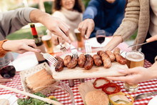 A Company Of Young People Came Together For A Barbecue.