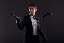Image Of Mafia Man With Emerging Tie In Leather Gloves With Gun