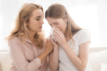 Sticker - A woman comforts a teenage daughter.