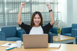 © reewungjunerr - Beautiful asian businesswoman working at the office  in the evening,Thailand worker happy after looking laptop,Success from work