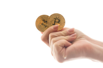 Two golden bitcoin in  hand digitall symbol of a new virtual currency isolated on white