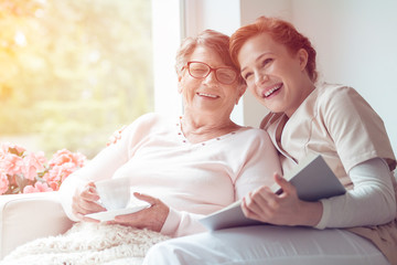 Wall Mural - Caregiver and senior woman laughing