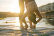© Arno Images - Young Japanese woman practicing yoga exercises near a river in a summer day in the city at sunset