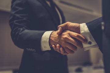 Business people shaking hands, finishing up a meeting,Negotiations were successfully