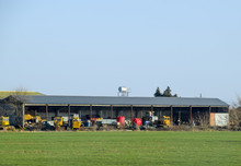 Tractors And Other Equipment Under The Awning In The Garage.