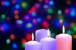 Christmas violet, purple and pink candles. Third Gaudete Sunday of the Advent. Shepherd Joy Candle. Xmas concept on a bokeh background.