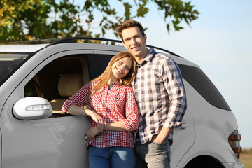 Sticker - Beautiful young couple standing near car outdoors