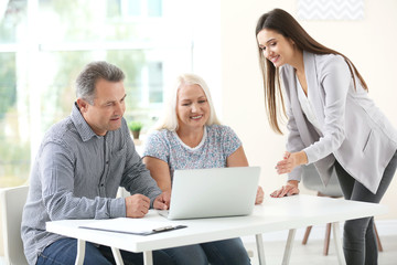 Sticker - Female insurance agent consulting senior couple in office