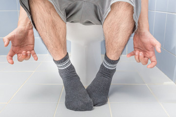 Man sitting on toilet, diarrhea