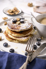 Wall Mural - Pile of american pancakes with blueberries and powdered sugar.