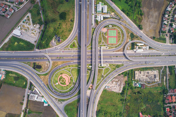 Wall Mural - Intersection traffic circle road with car and green tree