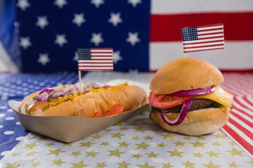 Wall Mural - Burger and hot dog on wooden table with 4th july theme