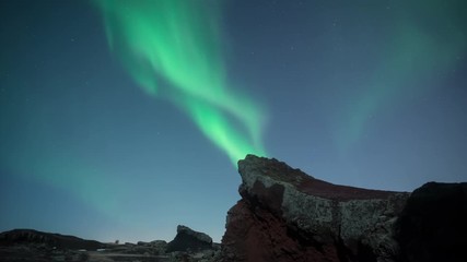 Wall Mural - aurora borealis swirling over moonlit jagged volcanic terrain iceland