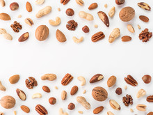 Pattern Of Nuts Mix With Copy Space. Various Nuts Isolated On White. Pecan, Macadamia, Brazil Nut, Walnut, Almonds, Hazelnuts, Pistachios, Cashews, Peanuts, Pine Nuts. Top View Or Flat-lay. Copy Space