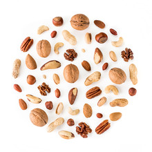 Pattern Of Nuts In Circle Form. Various Nuts Isolated On White. Pecan, Macadamia, Brazil Nut, Walnut, Almonds, Hazelnuts, Pistachios, Cashews, Peanuts, Pine Nuts. Top View Or Flat-lay. Copy Space