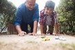 © wavebreak3 - Boy and grandfather playing with toy cars