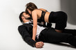 young handsone businessman with beautiful girl in skirt and lingerie lying on floor