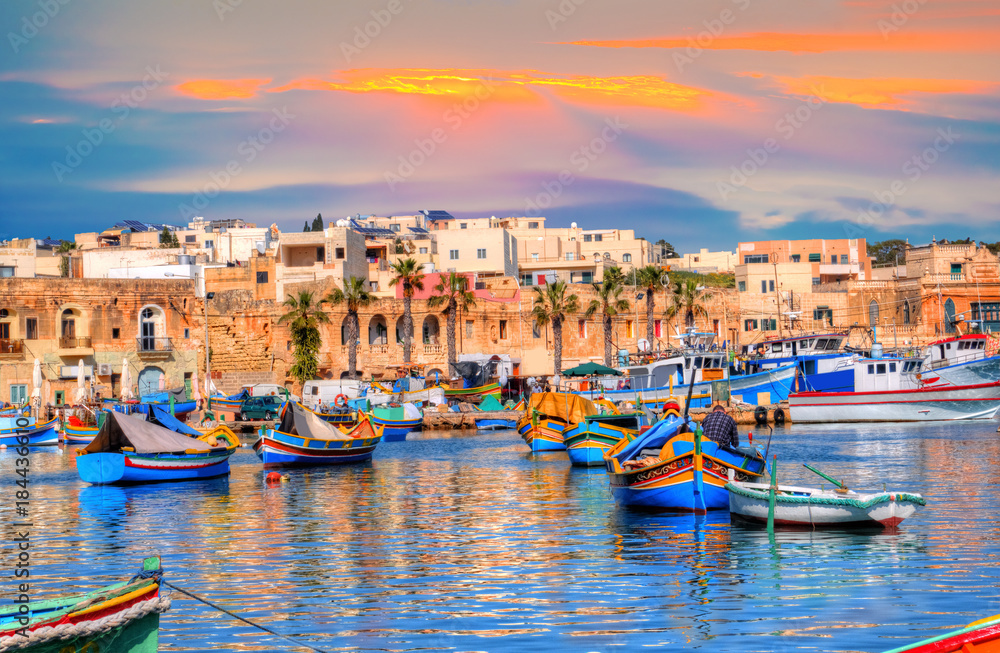 Marsaxlokk village port of Malta, illuminate by sunset light, European travel in beautiful place - obrazy, fototapety, plakaty 