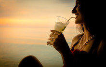 Woman Tourist In Summer Vacation, Drinking Cocktail At Sunset