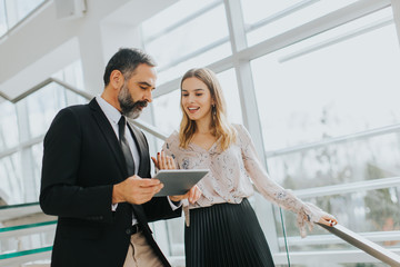 Business couple with digital tablet in office