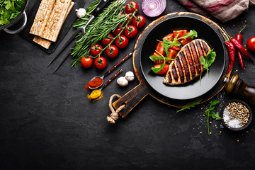 Canvas Print - Grilled chicken fillet on black background, top view