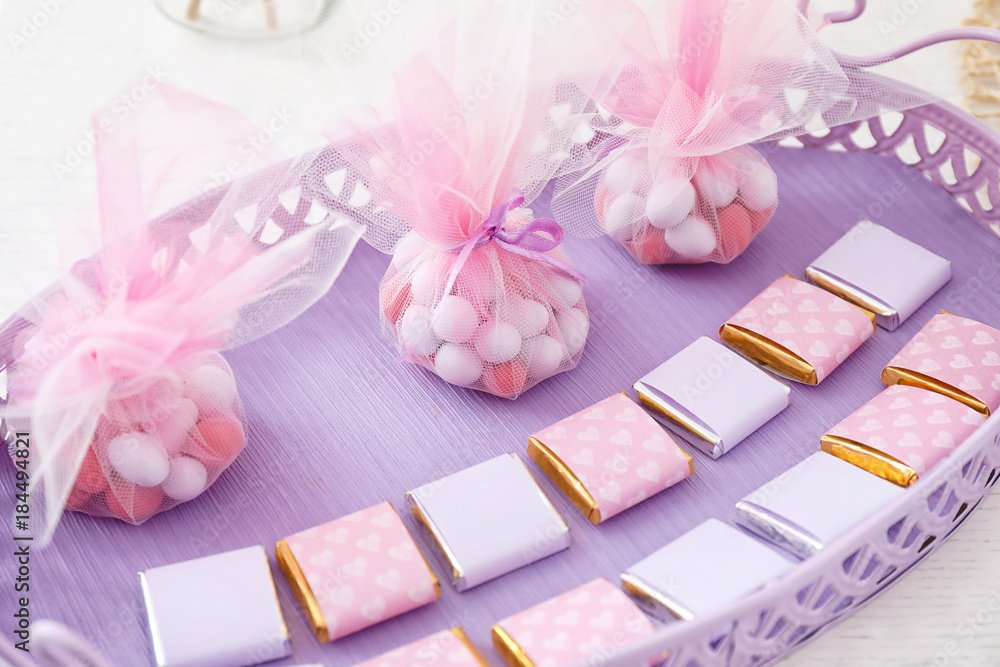 Tray with treats for baby shower party on table