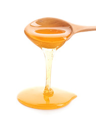 Poster - Honey dripping from spoon on white background