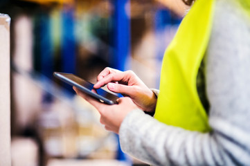 Wall Mural - Woman warehouse worker with tablet.