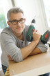 © goodluz - Portrait of cheerful man with electric drill