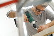 © goodluz - Man assembling DIY furniture using electric drill