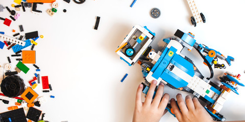 Robot from the plastics details programmed on the computer, robotics background