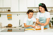 © Peakstock - happy mother and daughter knead a dough