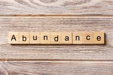 Abundance Word Written On Wood Block. Abundance Text On Table, Concept