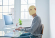 Man in crash test dummy mask in an office