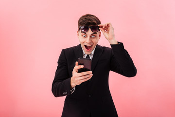 Poster - Surprised happy man using smartphone isolated