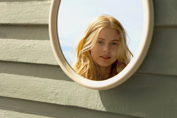 Young Woman Looking in Mirror outside