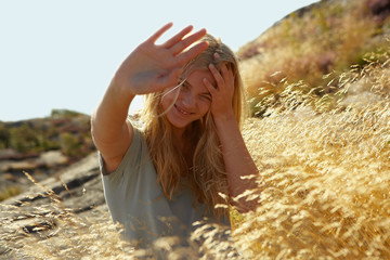 Young Woman Sitting in Long grass