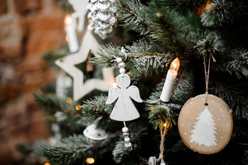 Christmas tree branches decorated with snow, garlands and toys