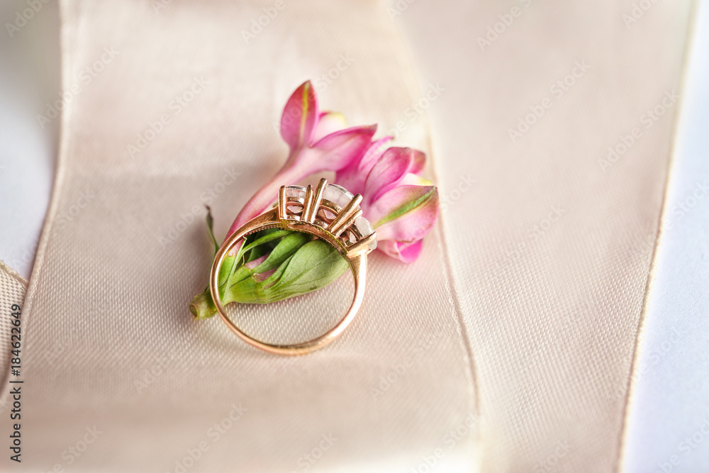 Beautiful engagement ring with flower on ribbon