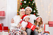 © snedorez - New Year's photo of family at New Year's pine