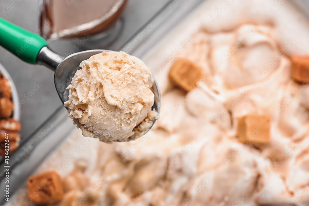 Spoon with delicious ice cream, closeup