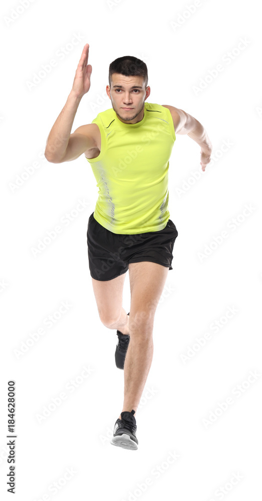 Young man in sportswear running against white background