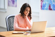 © Africa Studio - Young woman using laptop in office