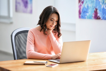 Sticker - Young woman using laptop in office