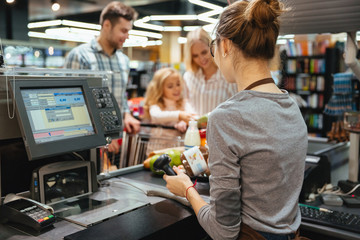 Poster - Beautiful family standing at the cash counter