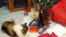 A Girl Gives A Gift With Cookies To Her Dog