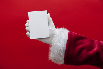 Santa Claus hand holding a blank white sign