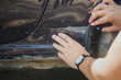 © kkolosov - Crop shot of man inspects car scratch dent damage