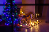 Fototapeta Pokój dzieciecy - Two little children sitting by a fireplace at home on Christmas